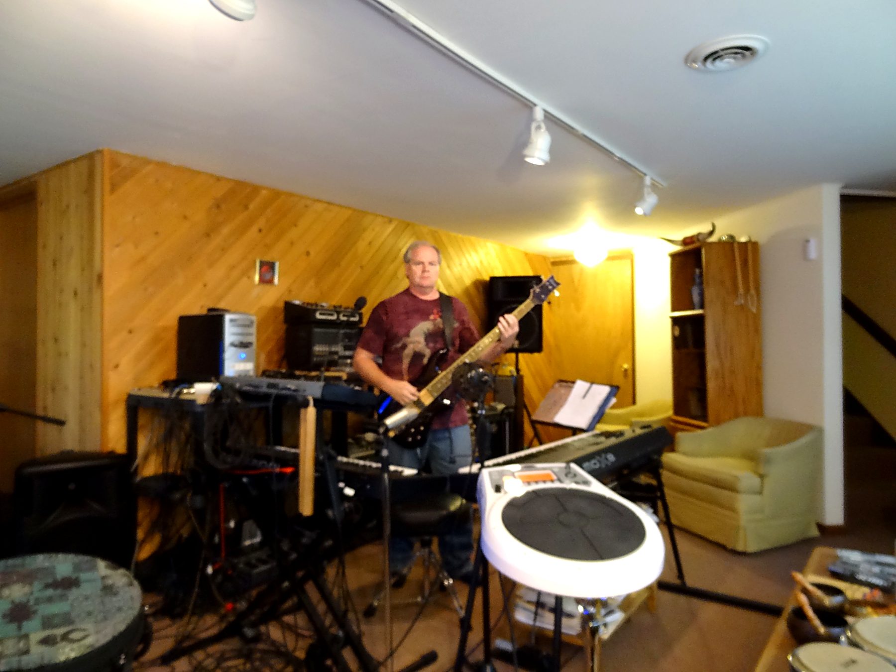 Joliet Jeff playing bass guitar in his home studio