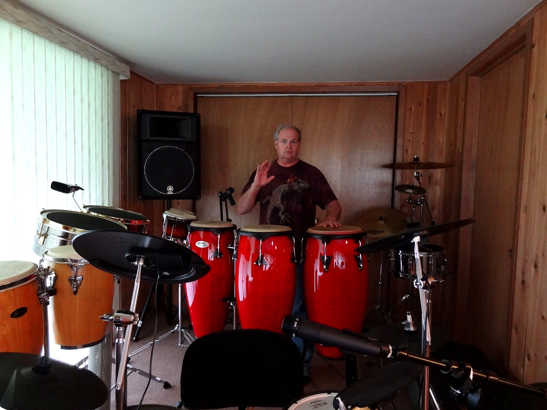 Joliet Jeff at a set of red congas and percussion