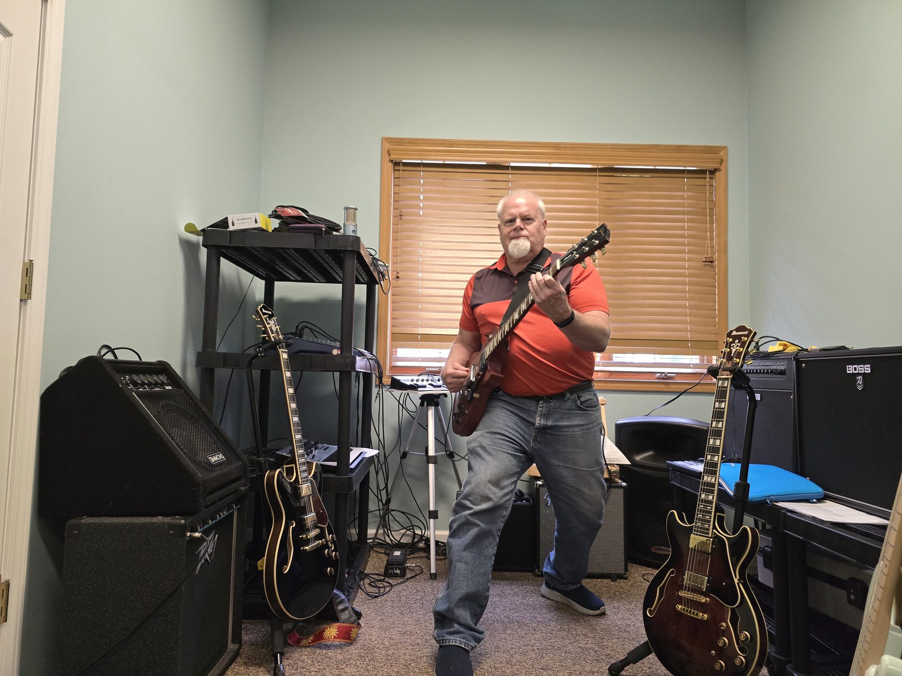 Joliet Jeff standing and playing his mahogany Gibson Les Paul in his home studio